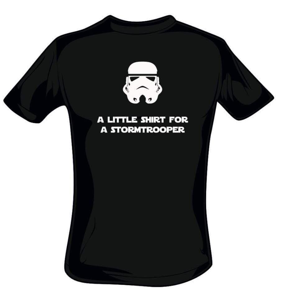 A black t-shirt featuring a white print of a stormtrooper helmet above white text saying 'a little shirt for a stormtrooper'.